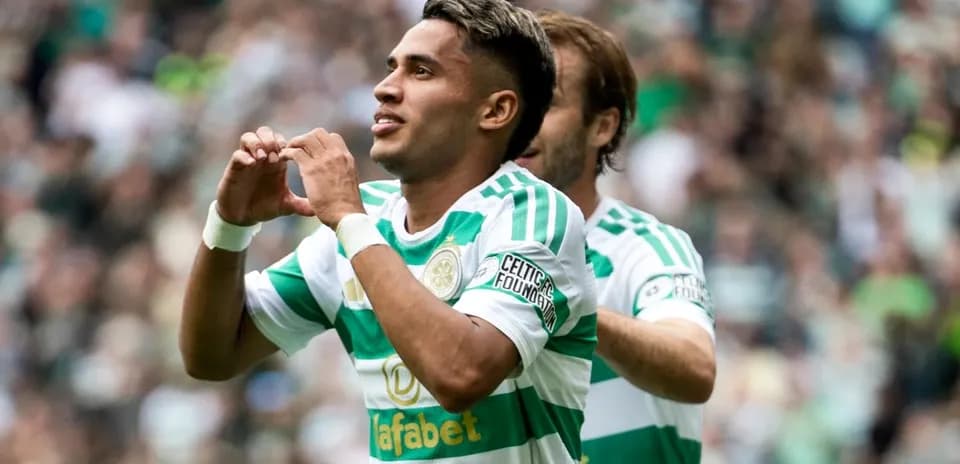 Celtic player celebrating a goal with teammates