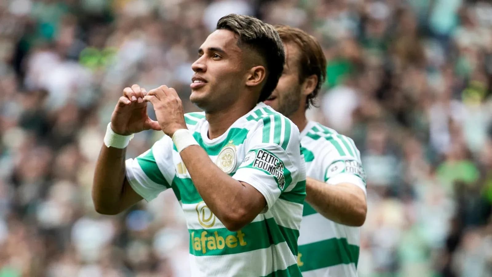 Celtic player celebrating a goal with teammates