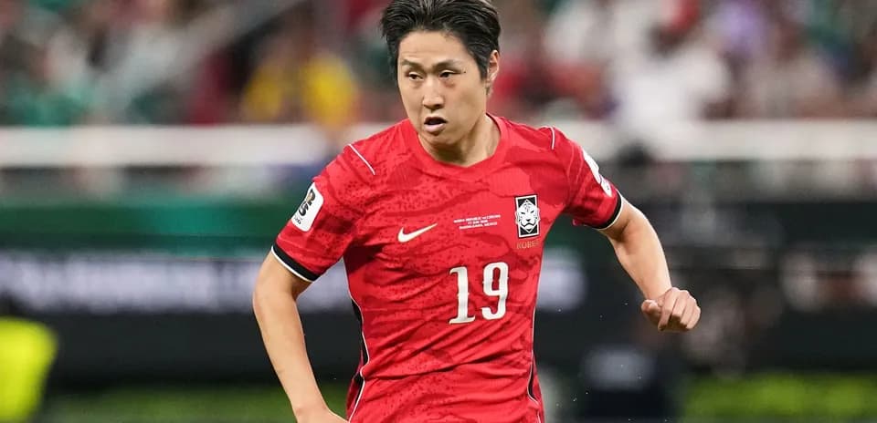 Player in red jersey running during a match