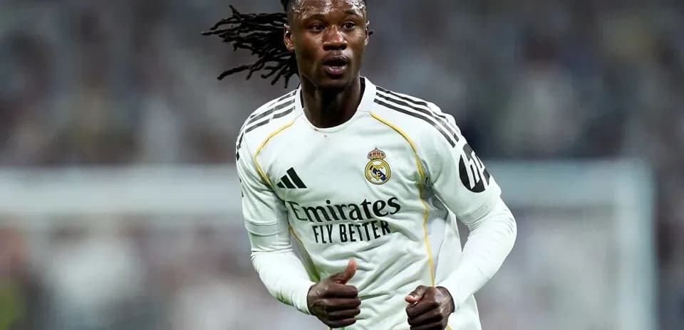 Player running on field wearing Real Madrid kit
