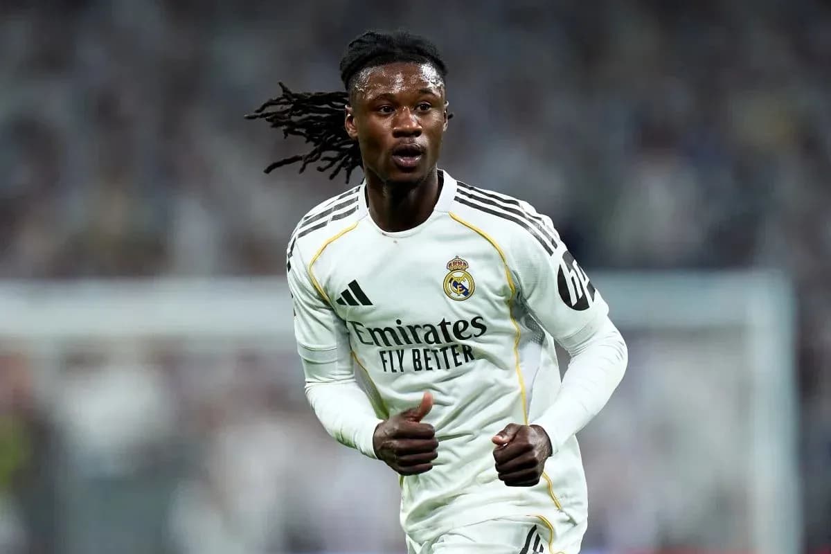 Player running on field wearing Real Madrid kit