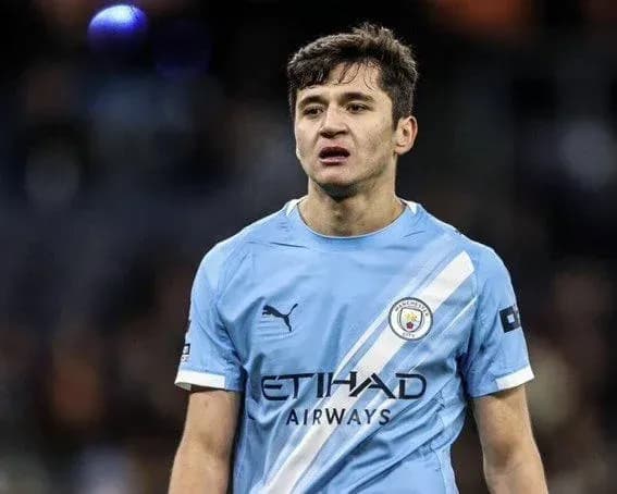 Player in blue Manchester City kit on the pitch