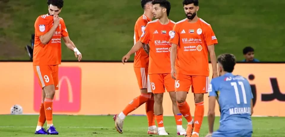 Ajman U23 players in orange jerseys during match