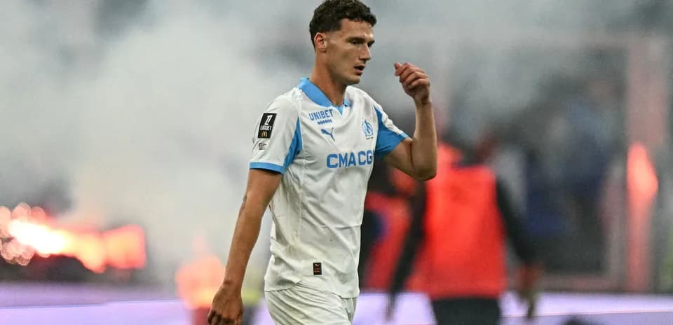 Player walking off field amid smoke during match