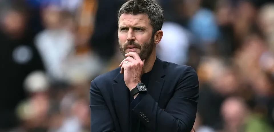 Coach observing match with thoughtful expression
