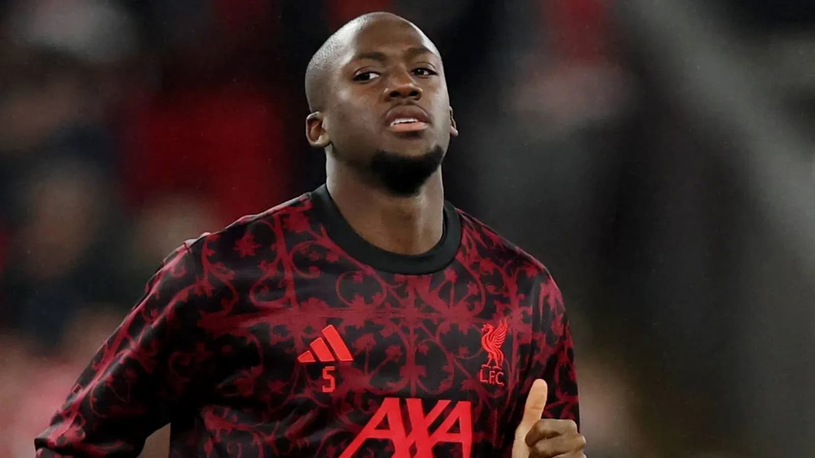 Player in Liverpool FC kit during match warm-up