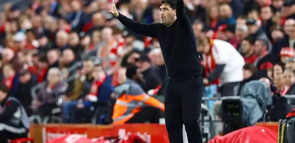 Coach gesturing from the sideline during match