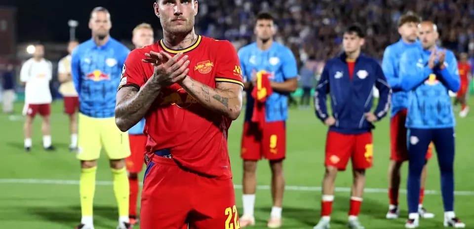 Player applauding while teammates stand behind him