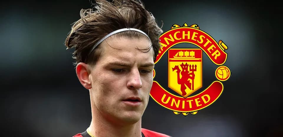 Player in red and black kit near Manchester United logo