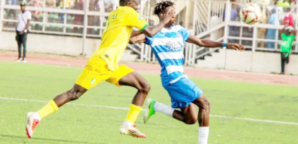 Ikorodu City player tackling Enugu Rangers player