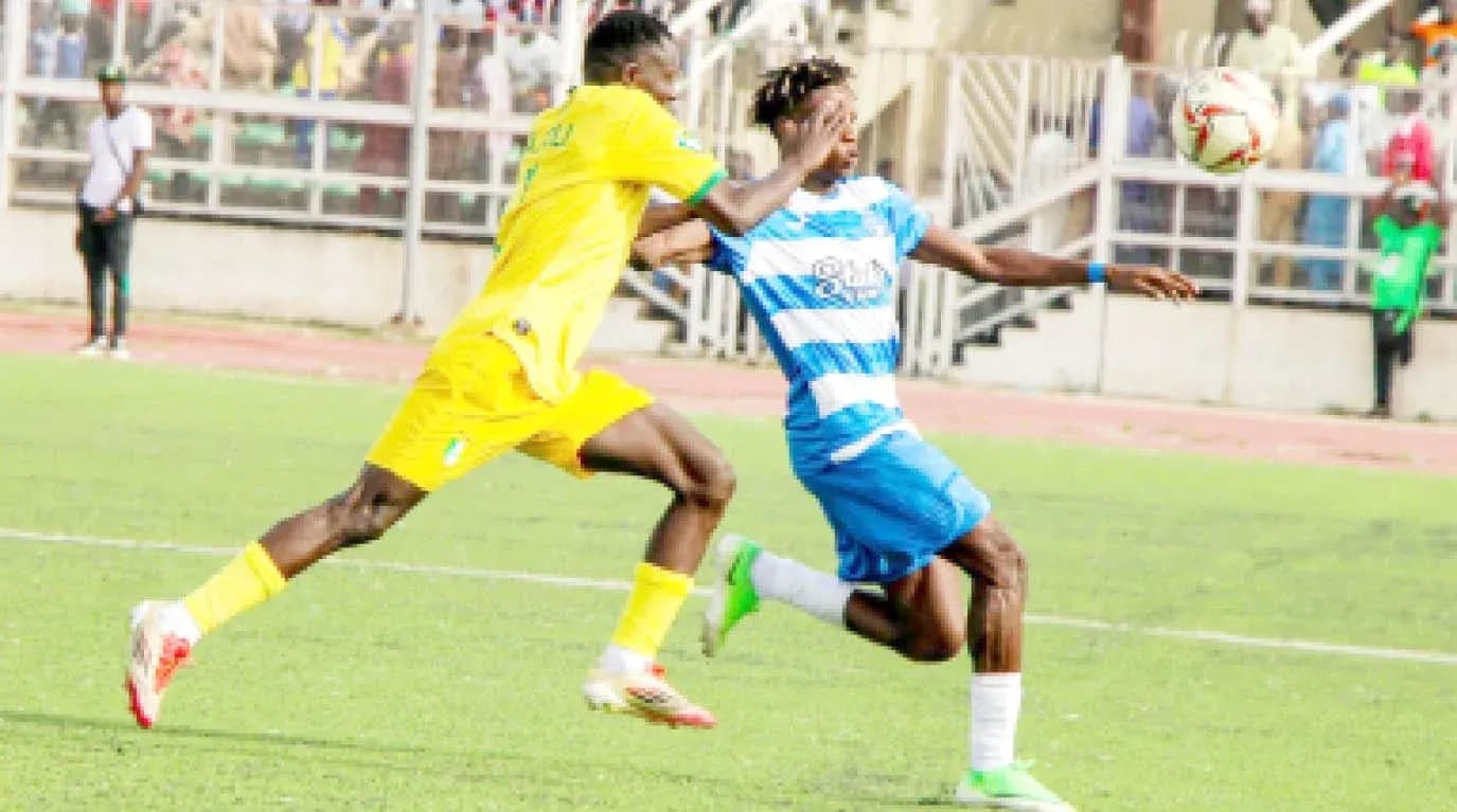 Ikorodu City player tackling Enugu Rangers player