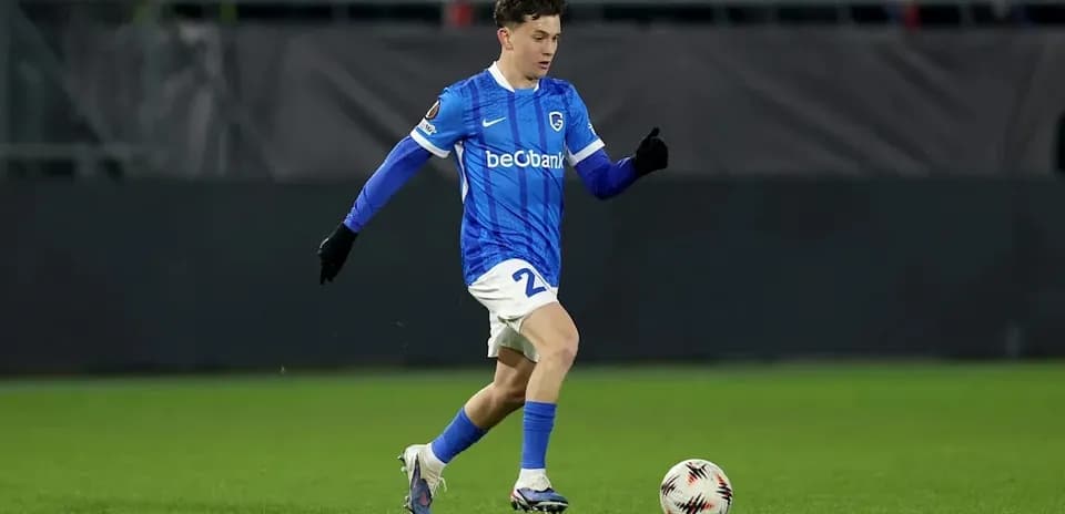 Player in blue kit dribbling a soccer ball