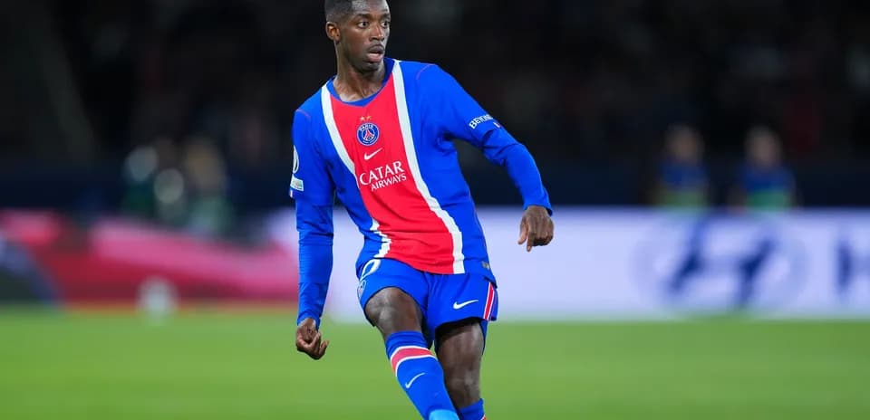 Player in PSG jersey dribbling during match