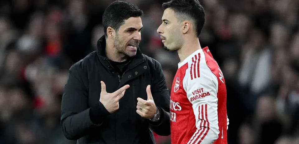 Manager discussing strategy with player during match