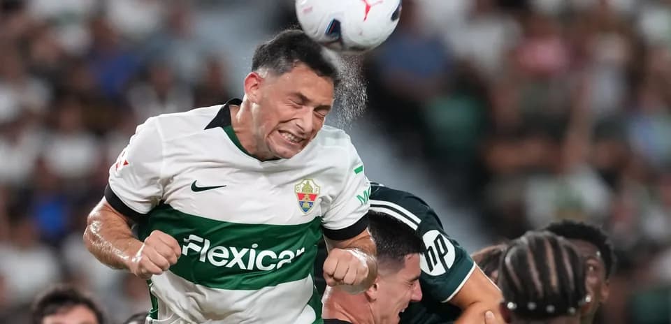 Elche player heading the ball during match
