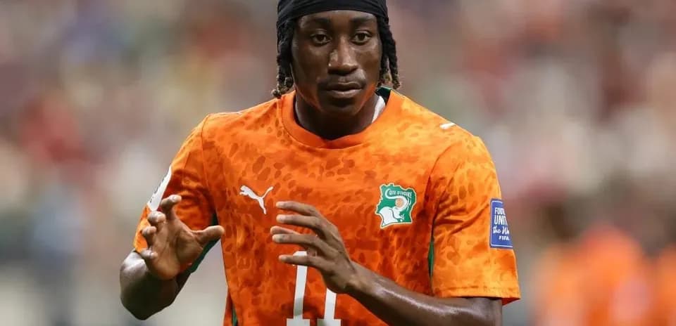 Player in orange jersey warming up before match
