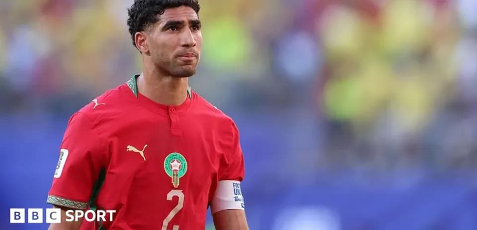 Football player in red Morocco jersey on field