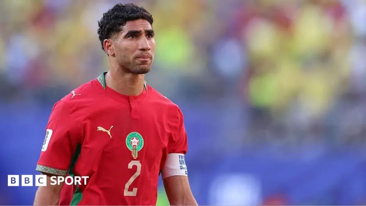 Football player in red Morocco jersey on field