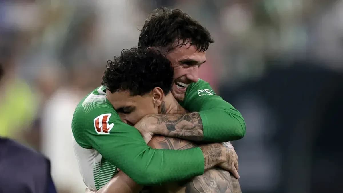 Two players celebrating with a hug after match
