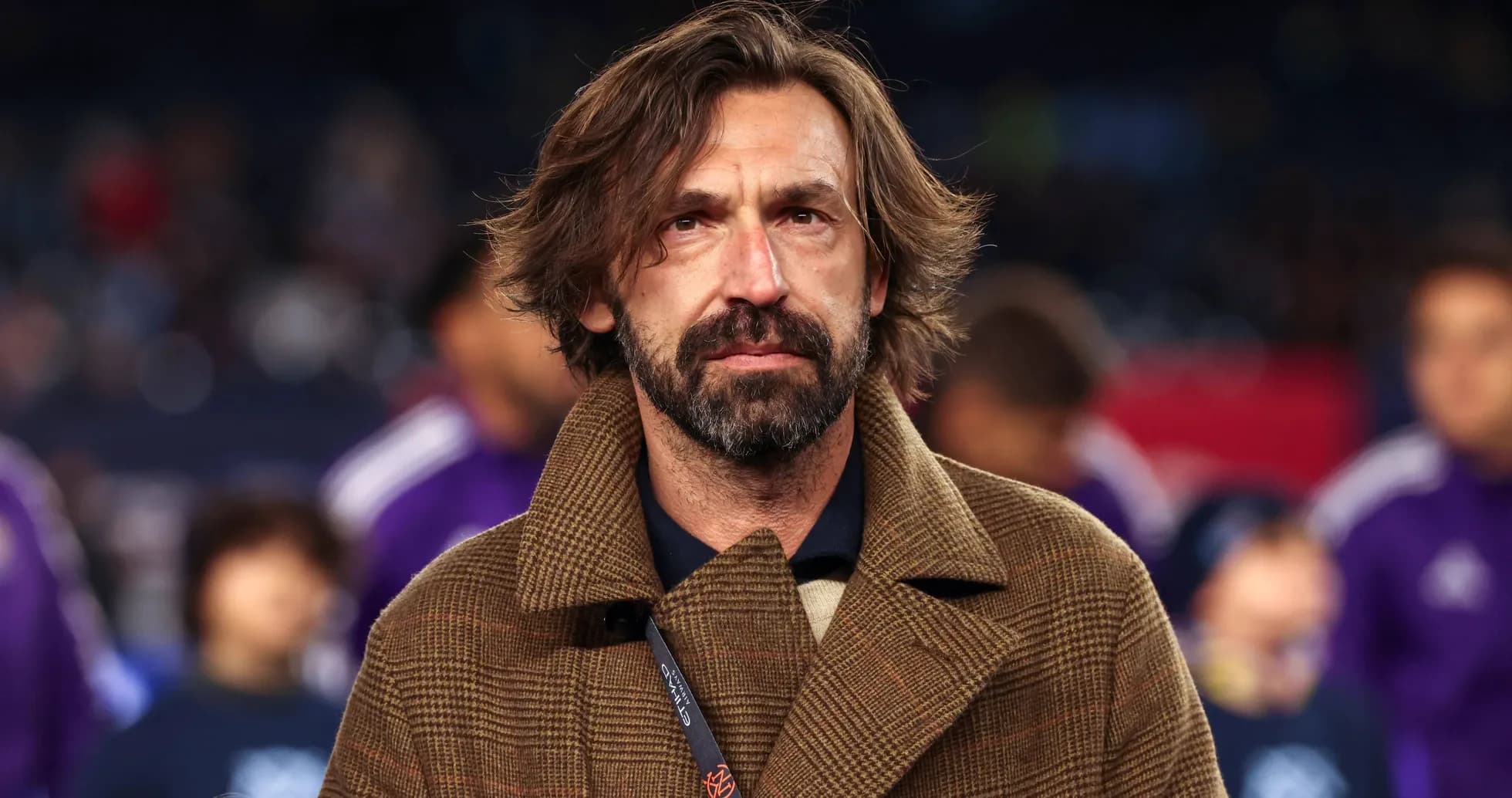 Coach wearing a brown coat on the sidelines