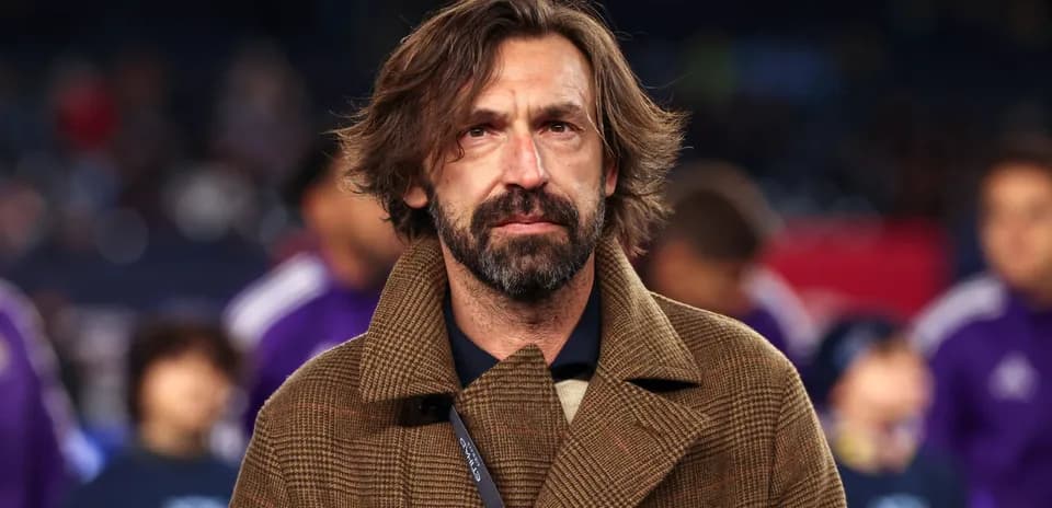 Coach wearing a brown coat on the sidelines