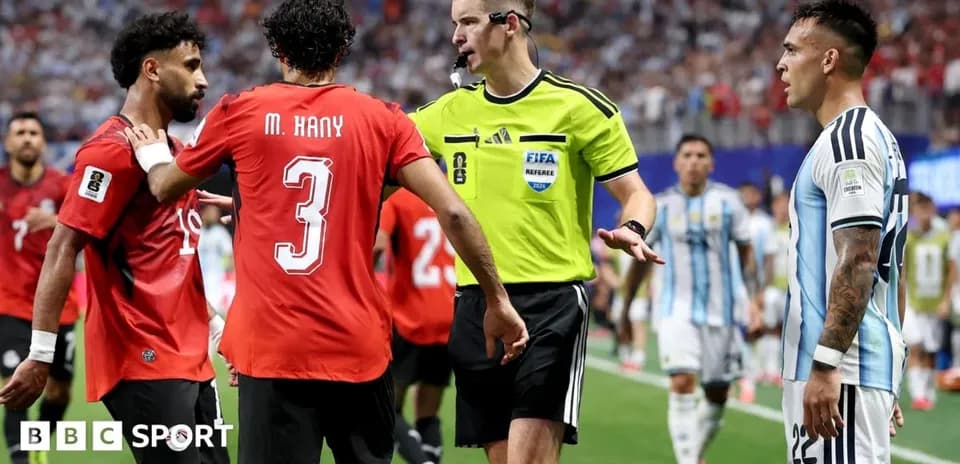 Players discussing with referee during tense match moment