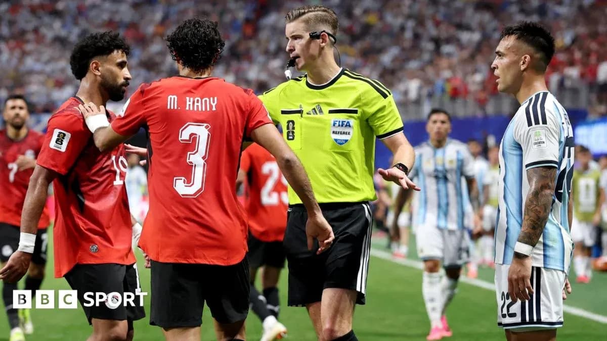 Players discussing with referee during tense match moment