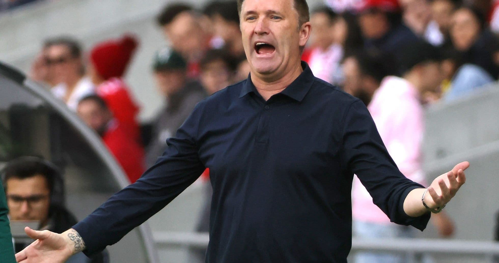 Coach gesturing during match from the sidelines