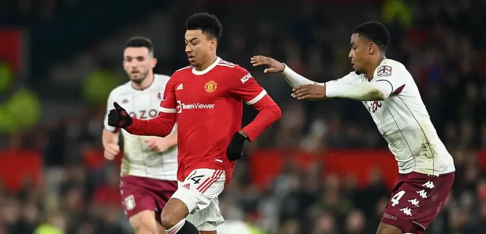 Manchester United player running with ball, defender close behind