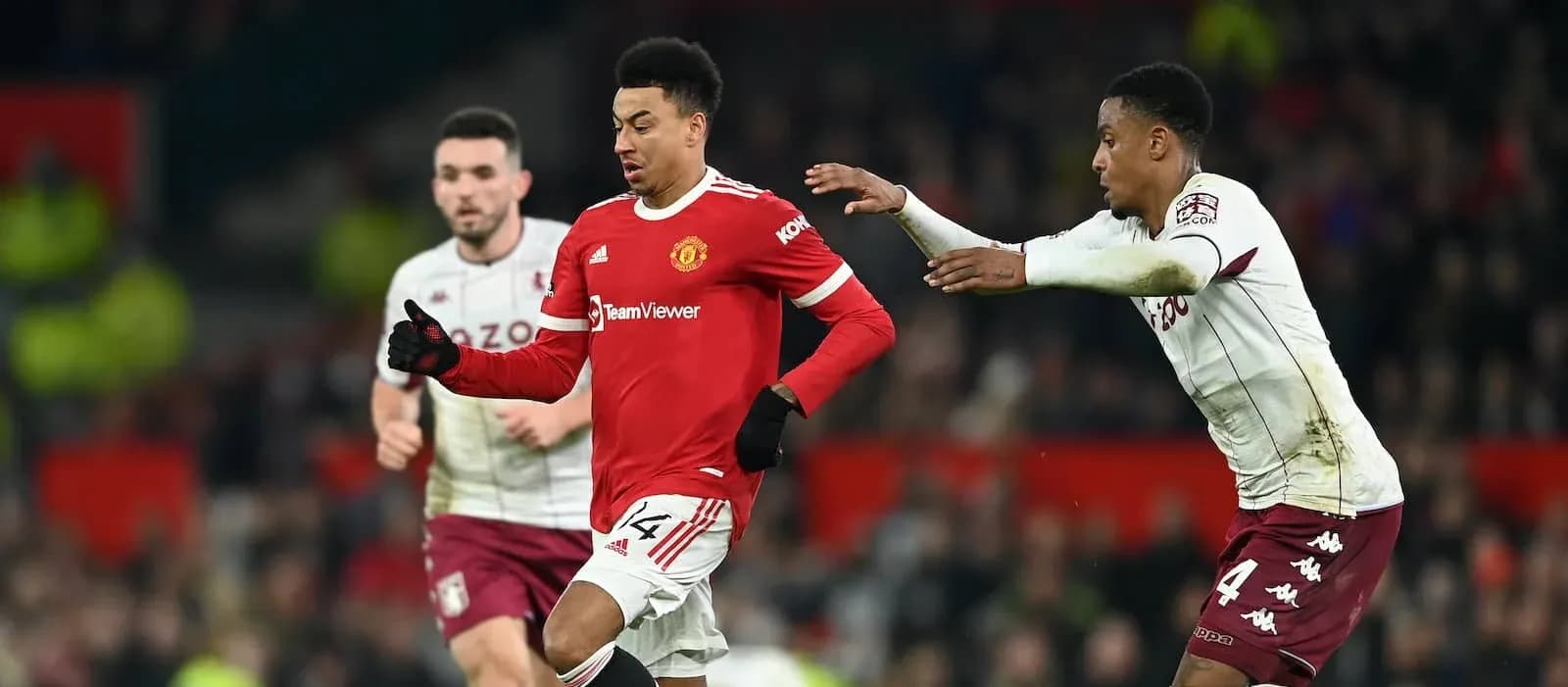 Manchester United player running with ball, defender close behind