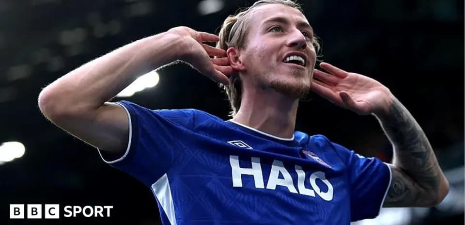 Player celebrating a goal with hand gesture