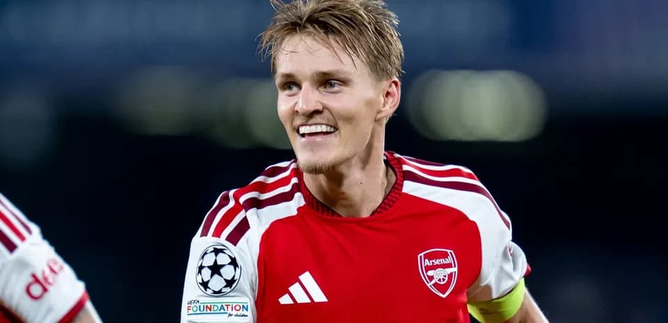 Player celebrating in Arsenal's red home kit