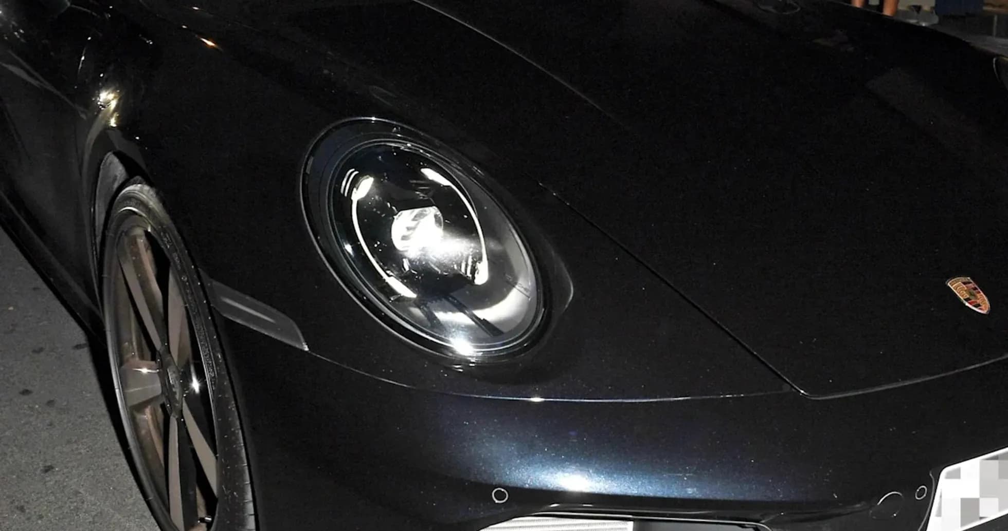 Two men in a Porsche parked at night