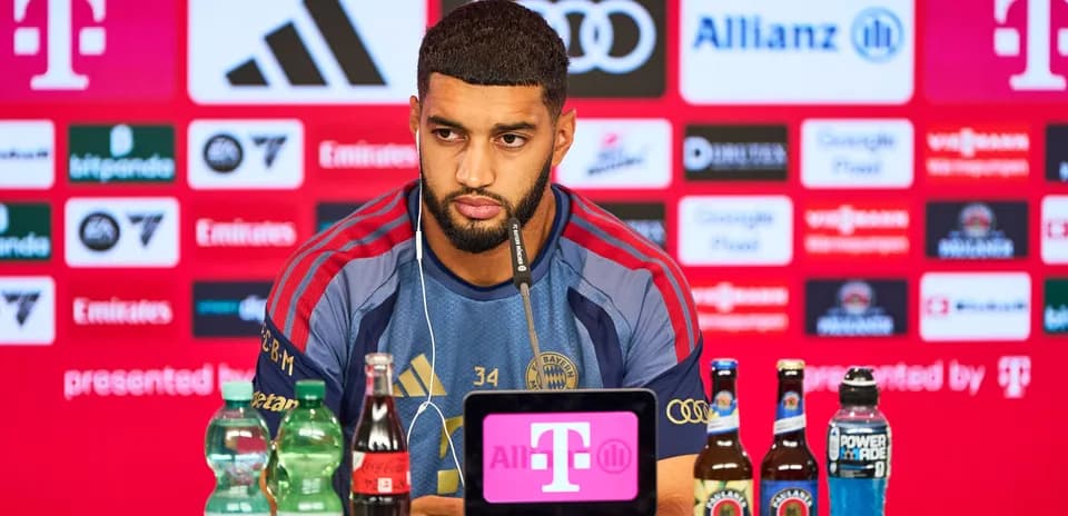Player at press conference with sponsor backdrop
