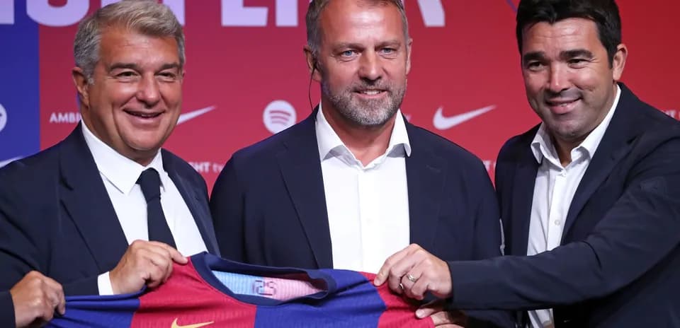 Three officials presenting a Barcelona jersey at event