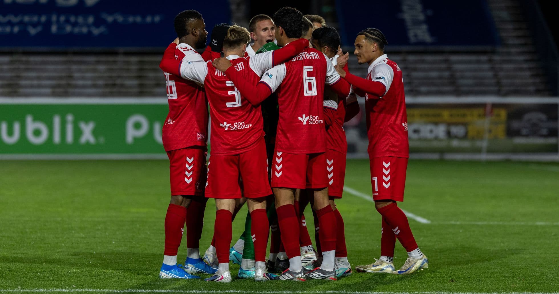 Players celebrating during Loudoun United match