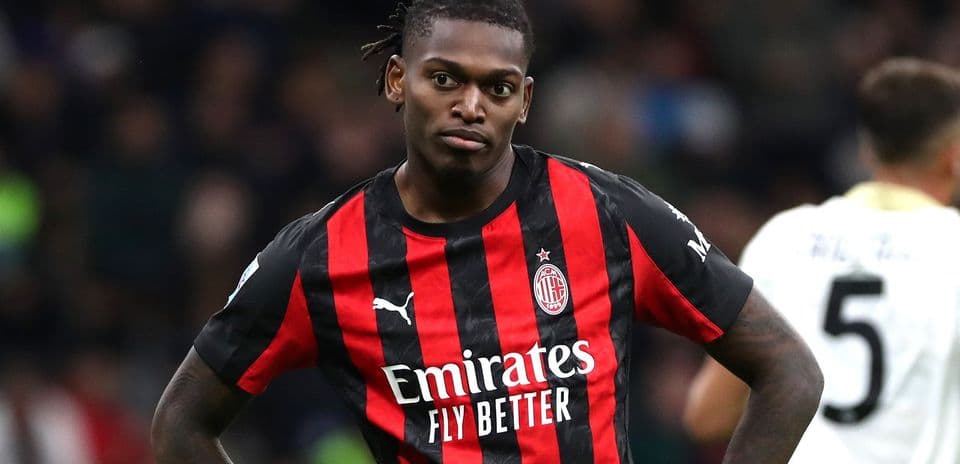 Player in AC Milan jersey during match action