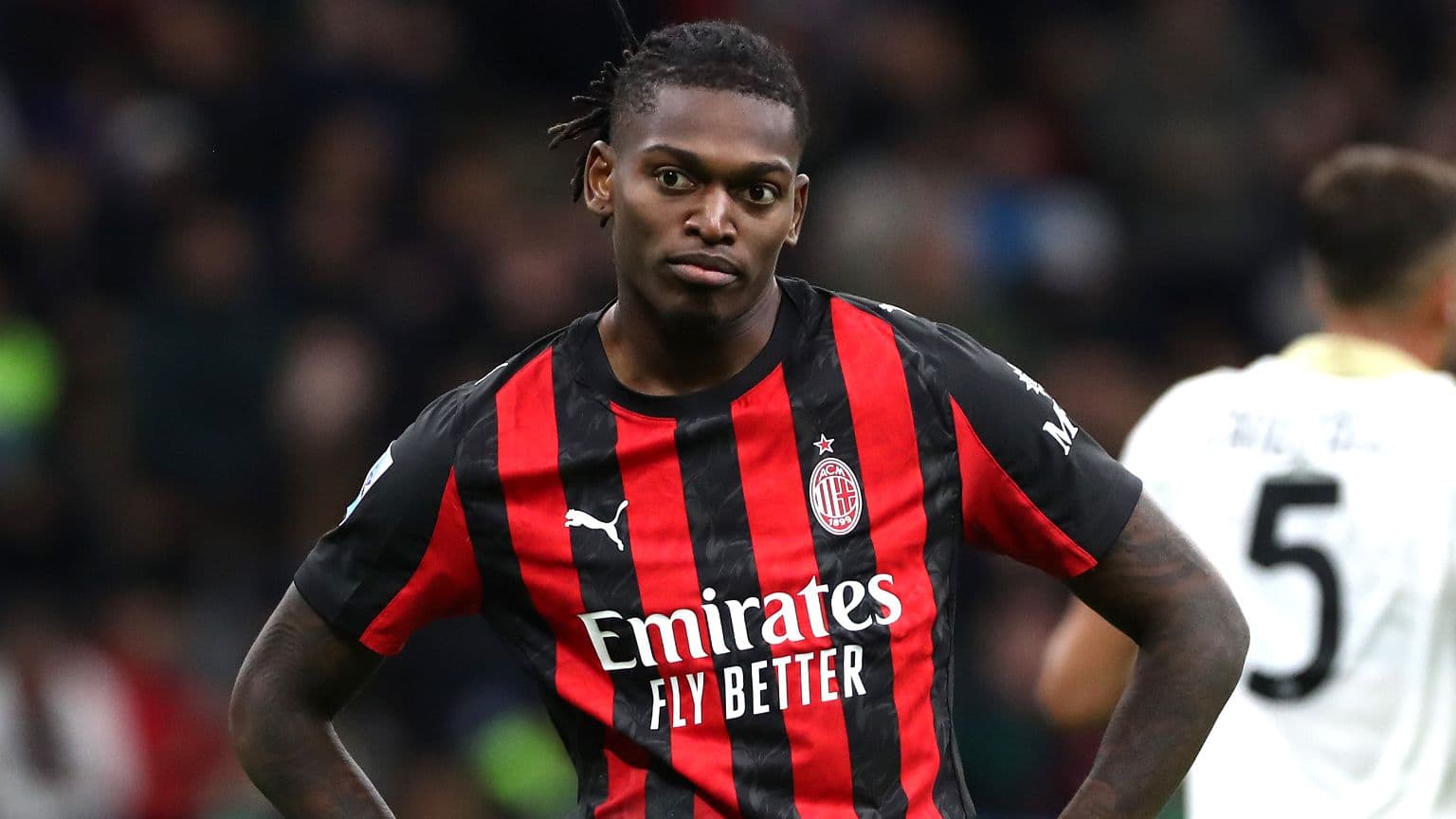 Player in AC Milan jersey during match action