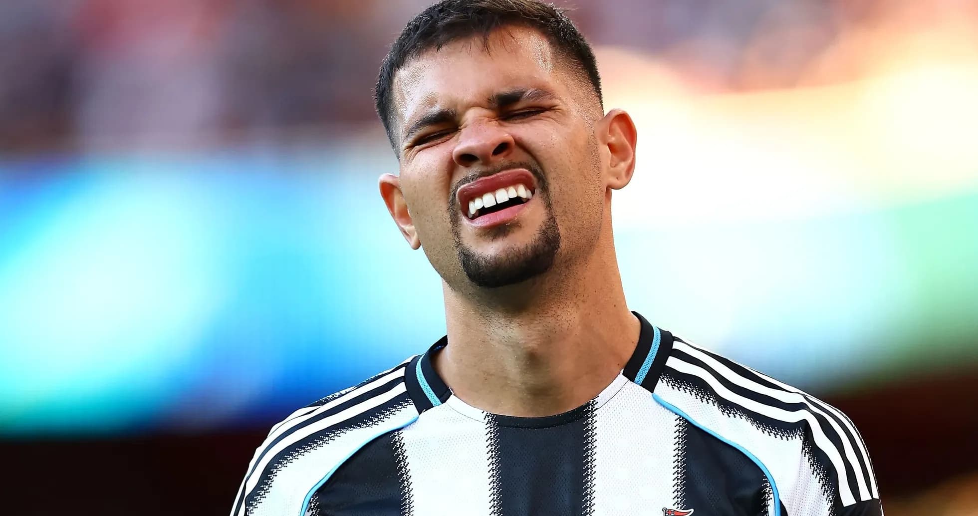 Player reacting during match wearing Newcastle jersey
