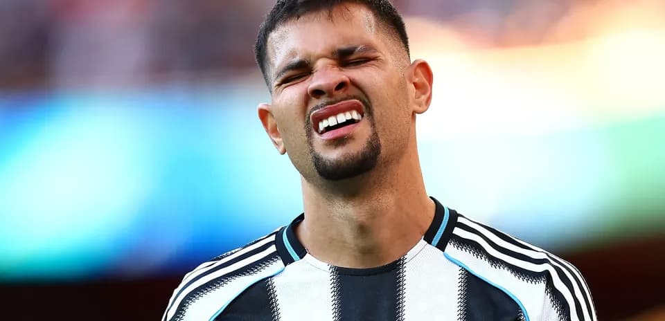 Player reacting during match wearing Newcastle jersey