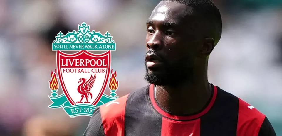 Player in kit with Liverpool logo in background