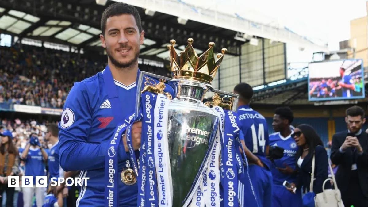 Player holding Premier League trophy at stadium
