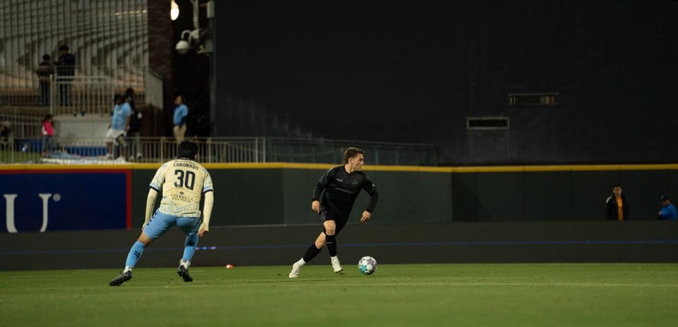 Player dribbling the ball during Colorado Springs match