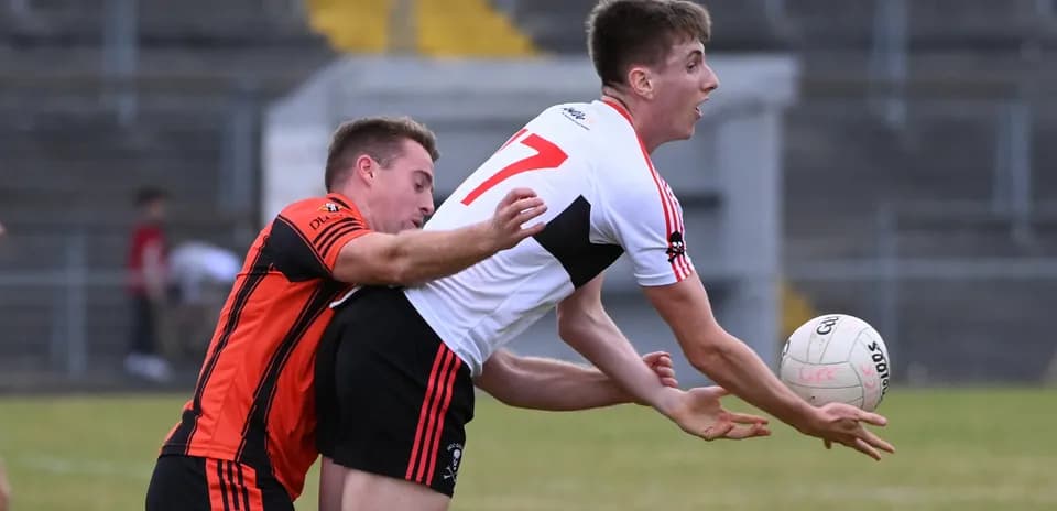Player in black jersey tackling opponent with ball