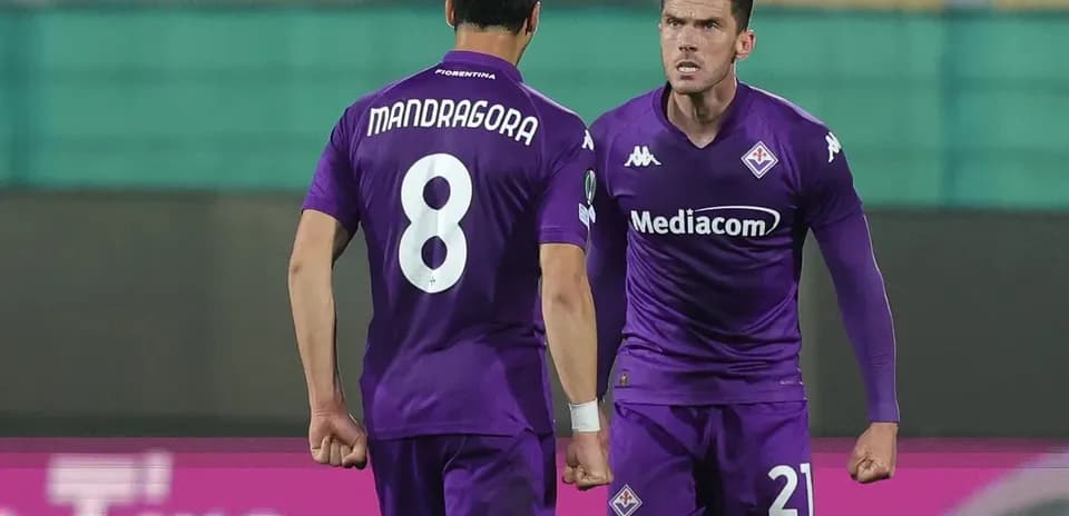 Two Fiorentina players celebrating on the pitch