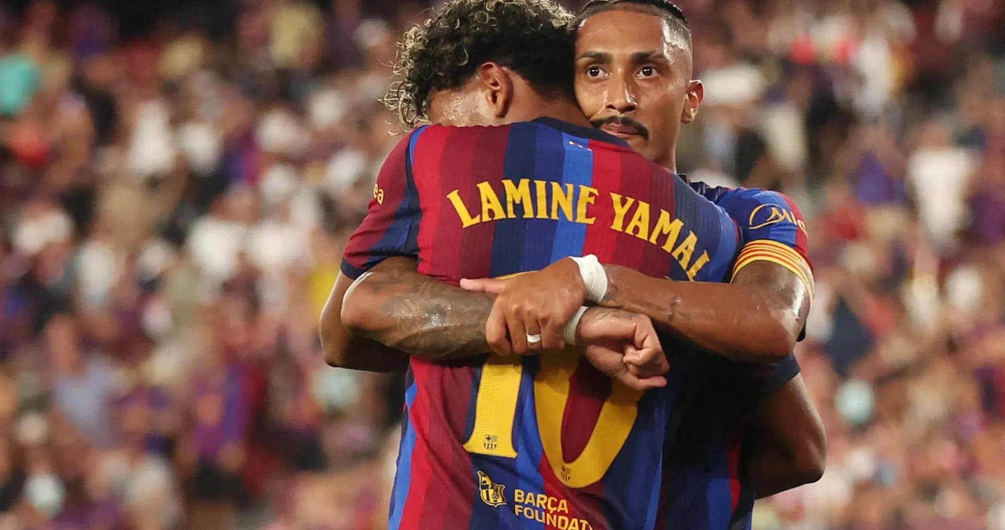 Barcelona players embracing during a match celebration