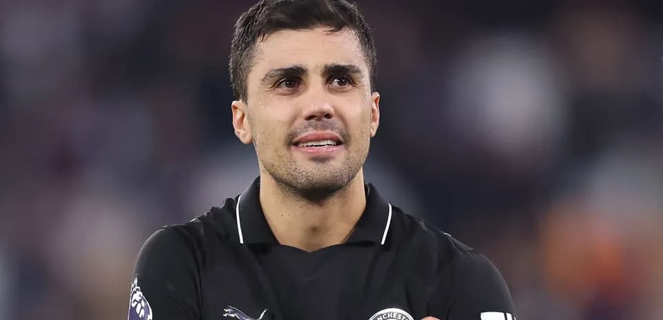 Player in black kit celebrating on the field