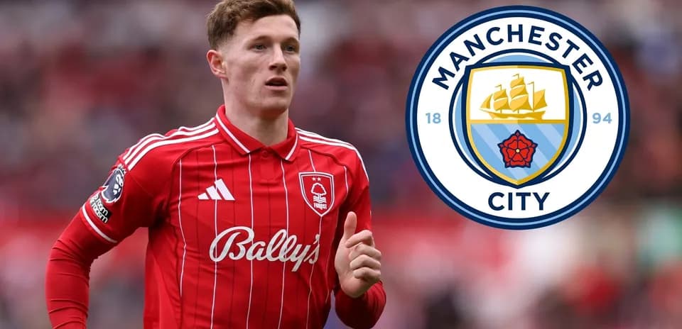 Player in red kit with Manchester City logo background