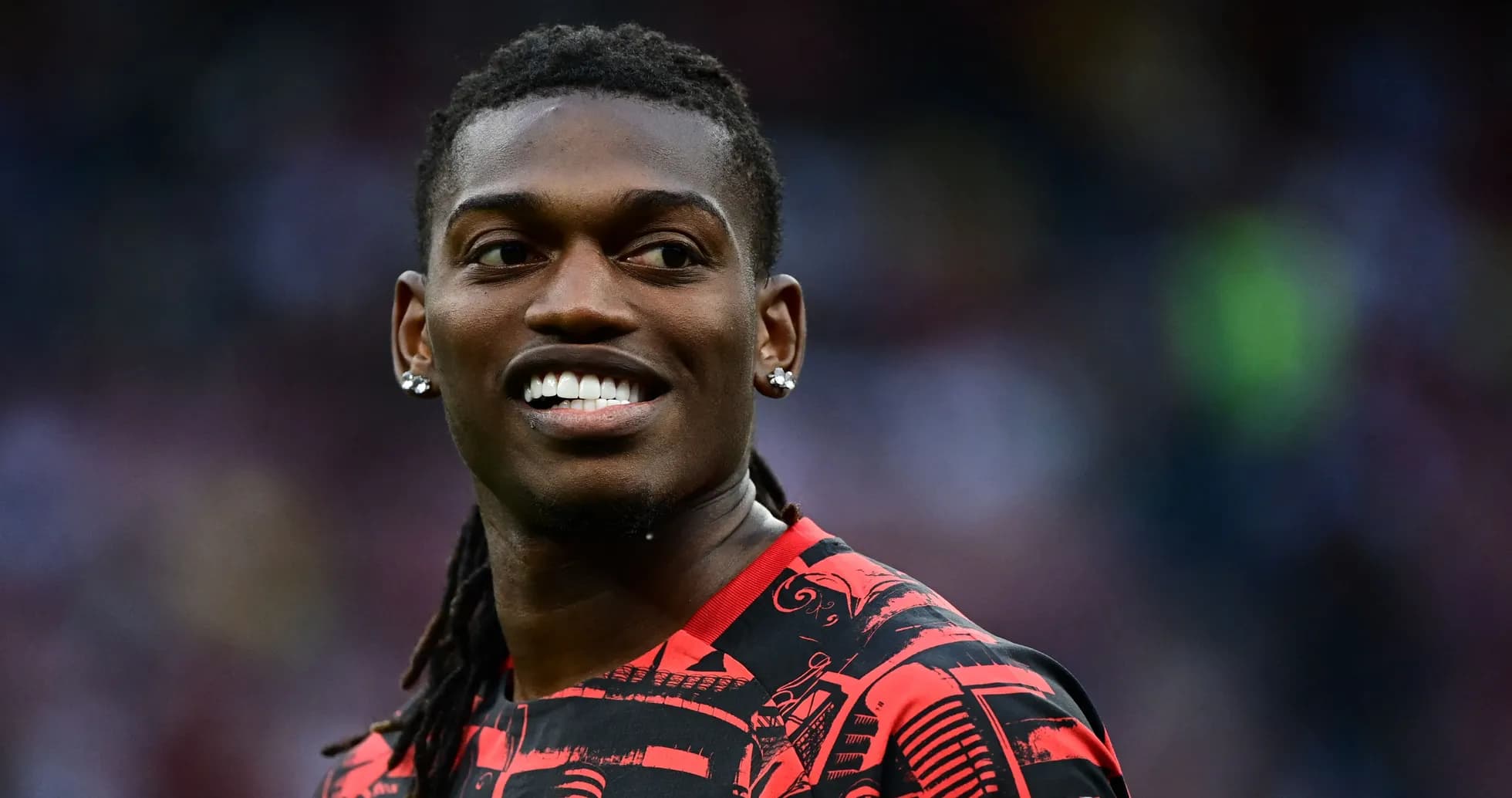 Player smiling during warm-up in red jersey