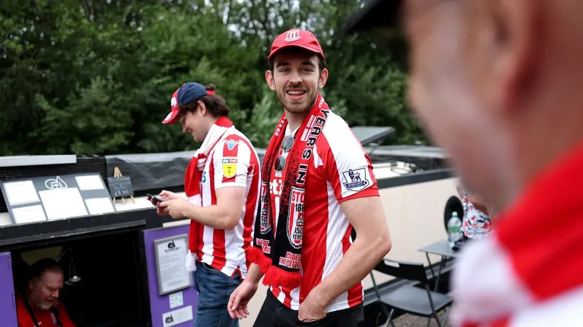 Fans wearing team jerseys and scarves at event